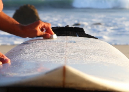 waxing a surfboard